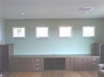 American Walnut TV unit with speaker boxes each end and black glass doors in centre