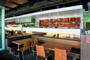 Seating and extended view of bar - Glass backing and shelves with feature lighting