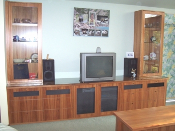 Blackwood TV display cabinet with black wire over entertainment doors and feature wire draw fronts to top draws. Glass doors and shelves with cabinet lights to display units