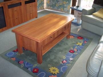 Matching Blackwood coffee table with solid timber legs and edge on top. One drawer under made to look like two with split fronts. Shelf below